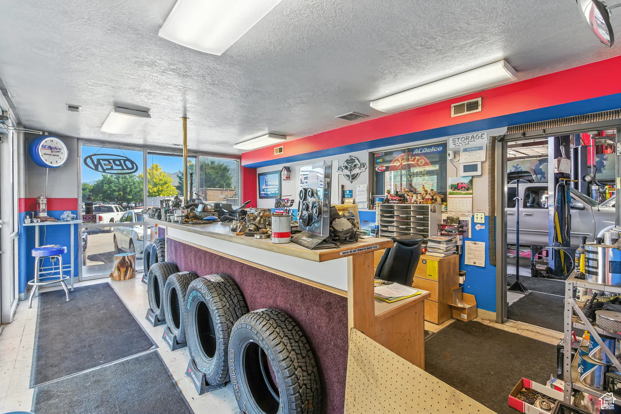 Misc room featuring a textured ceiling, a workshop area, and a wall of windows