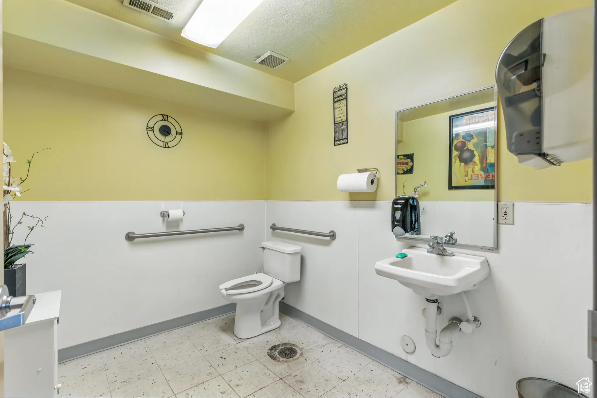 Half bathroom with toilet and light flooring