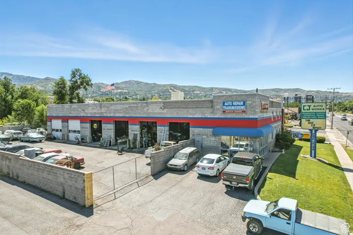 View of commercial property with a mountain view and uncovered parking