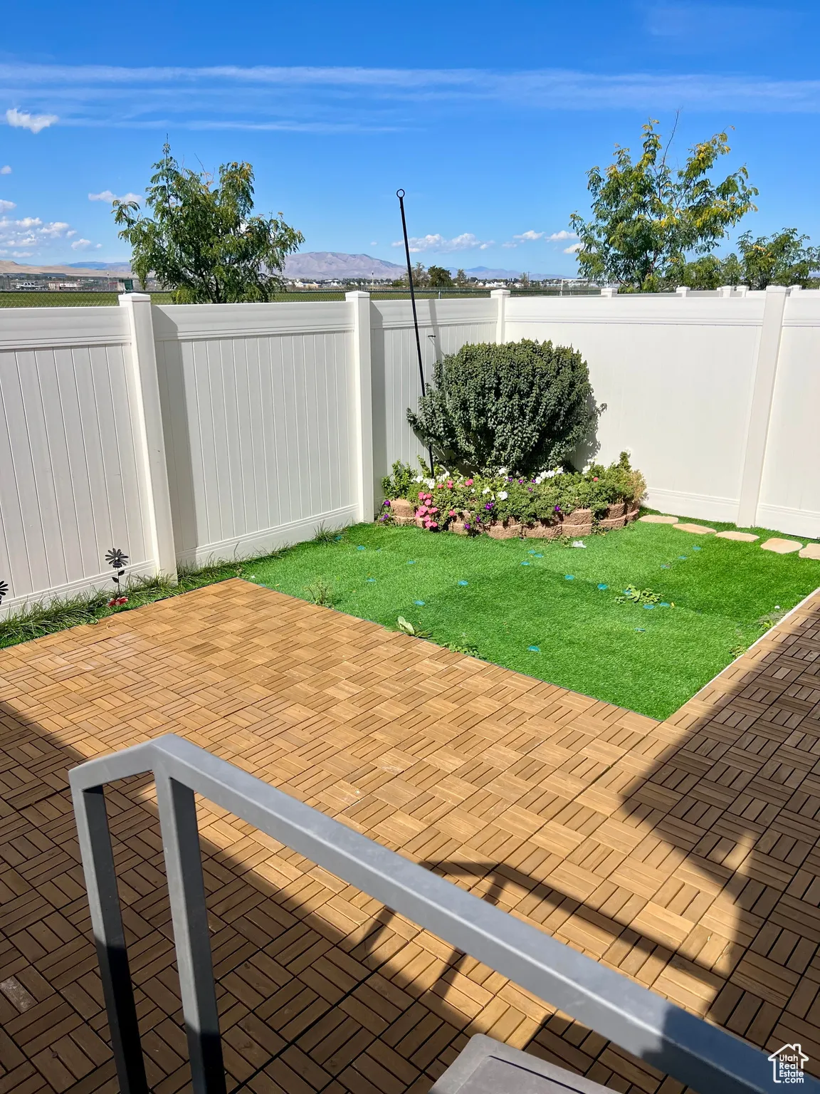 Patio with a fenced backyard.