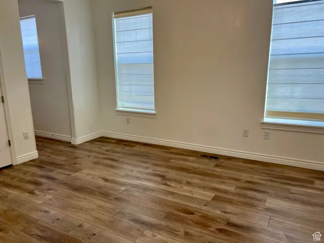 Main floor master bedroom with hardwood / wood-style floors
