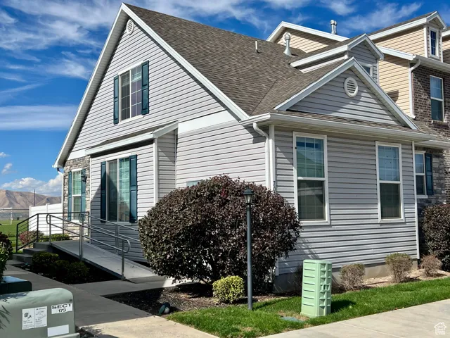 View of property exterior featuring a shingled roof
