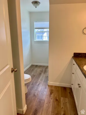 3/4 upstairs bathroom featuring light wood-style flooring and vanity
