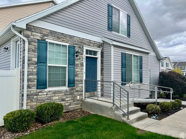 View of front of house with stone siding