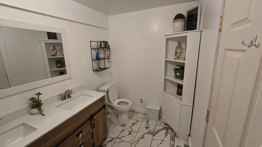 Double vanity with undermount sinks and wood-finish cabinetry