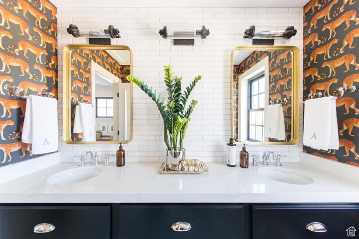 Bathroom with double vanity and decorative backsplash