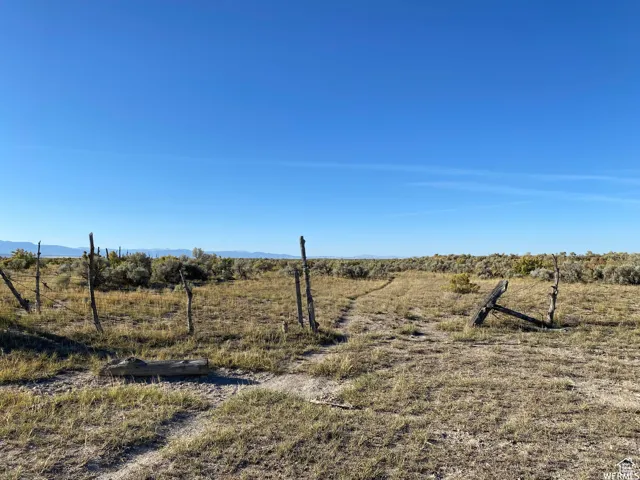 View of yard featuring a view of rural / pastoral area and a mountain view