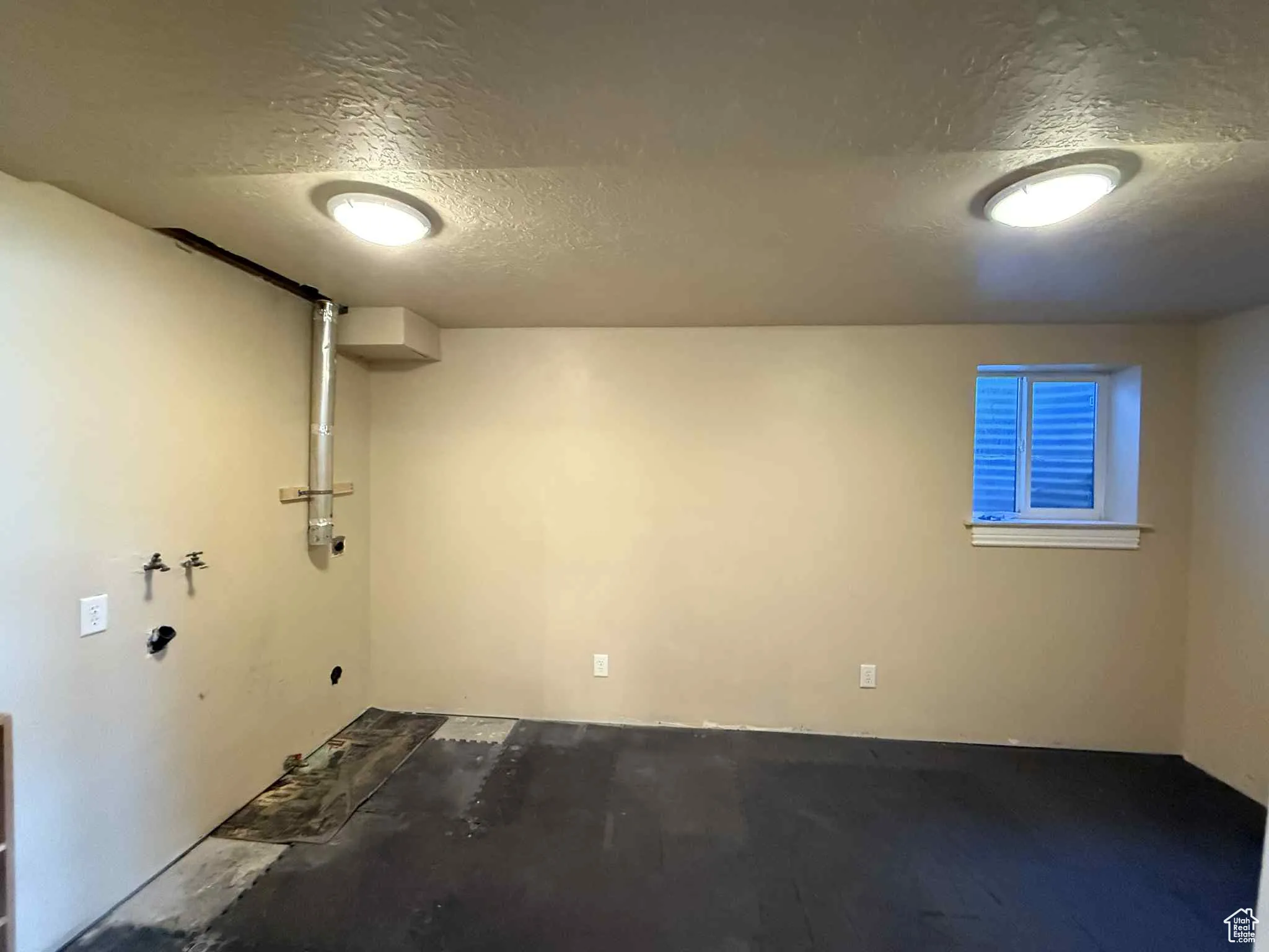 Basement laundry room with ample space for storage or tables