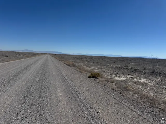 View of dirt / gravel road featuring a mountain view