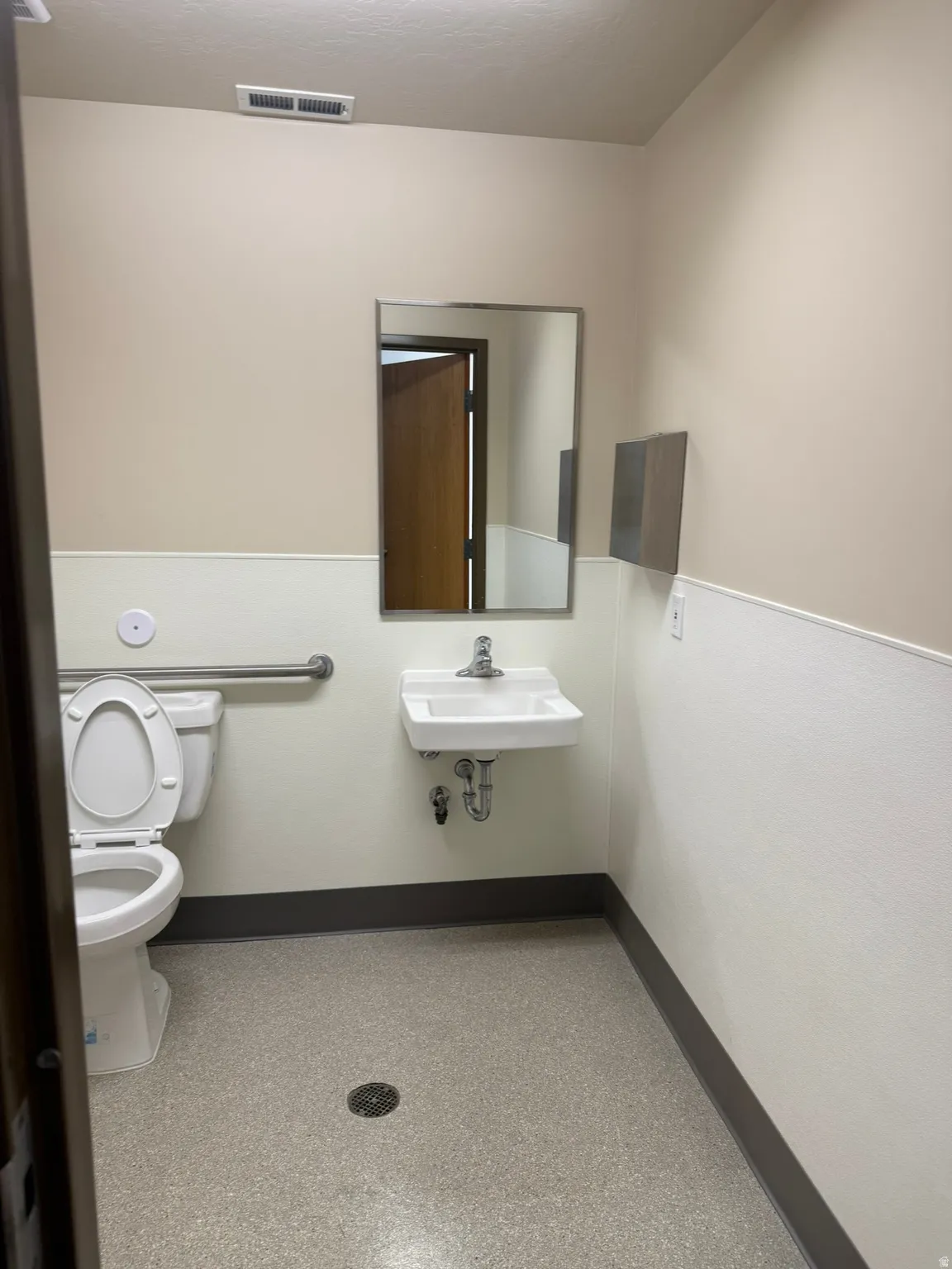 Half bath with baseboards and toilet