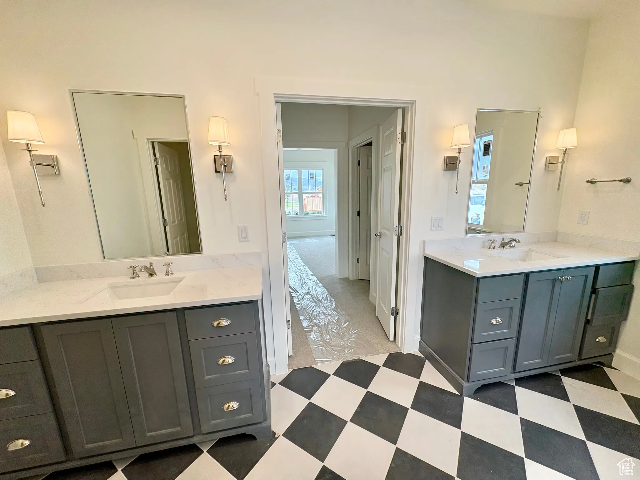Bathroom with two vanities and light floors