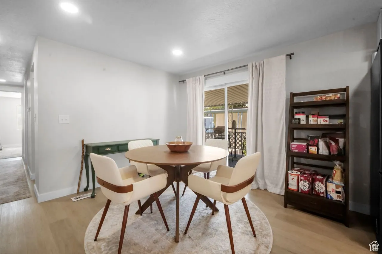 Dining room featuring light wood-style flooring and recessed lighting