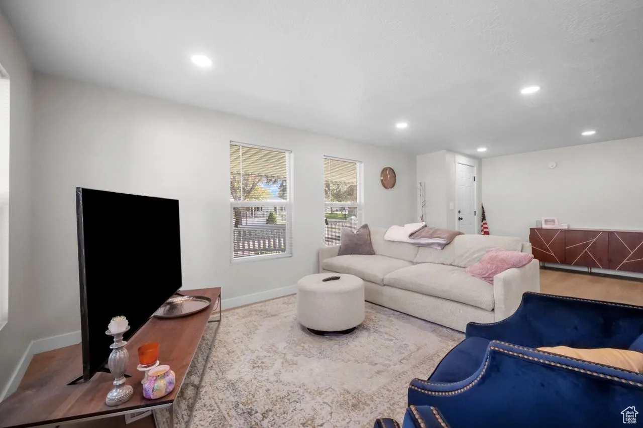 Living room with recessed lighting and wood finished floors