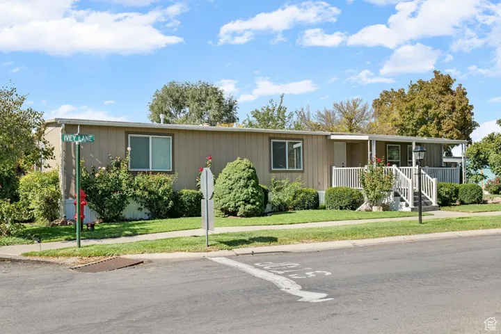 View of front of property with a front lawn and covered porch
