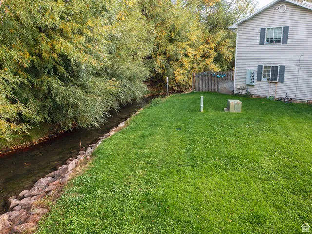 View of yard with a water view