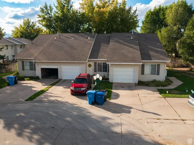 View of front facade with concrete driveway and roof with shingles