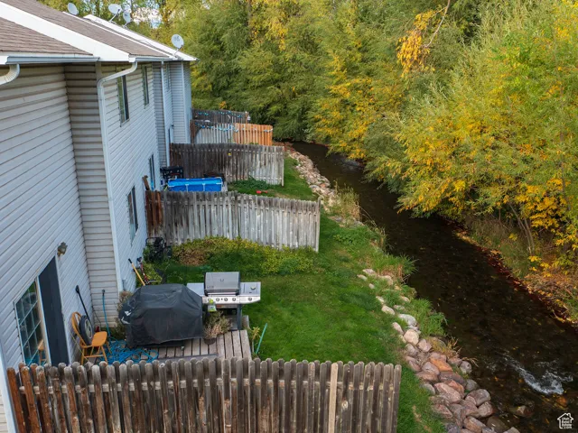 Fenced yard featuring radiator and a water view