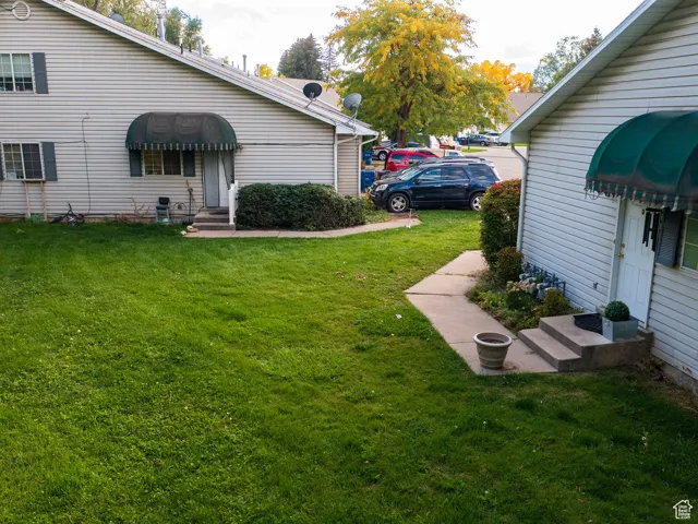 View of green lawn with entry steps