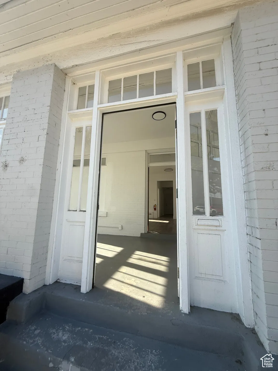 View of exterior entry featuring brick siding