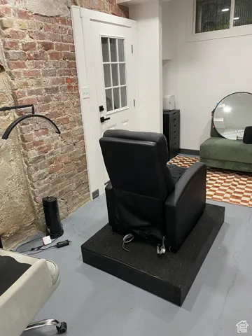 Interior space with brick wall and concrete flooring