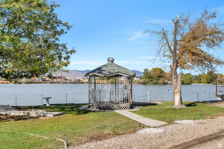 Dock with a lawn and a water and mountain view
