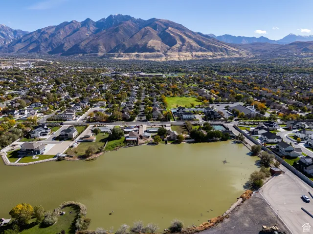 Aerial overview of property's location featuring nearby suburban area and a water and mountain view