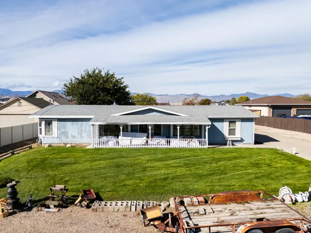 Single story home with a mountain view, a shingled roof, and a patio