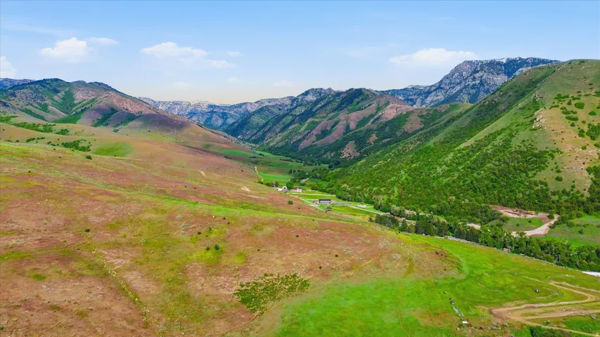 Expansive natural landscape featuring rolling hills and distant mountains