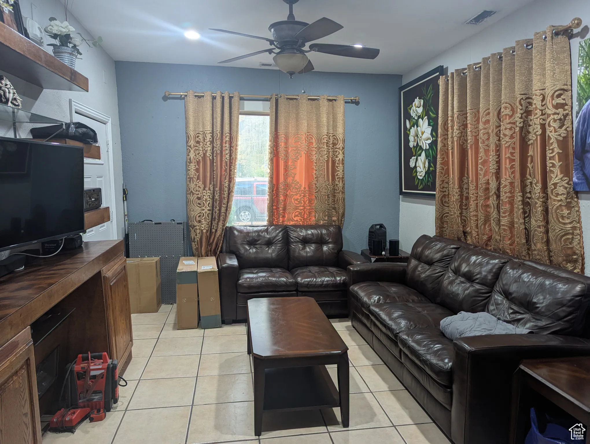 Living room featuring light tile patterned floors, ceiling fan, and recessed lighting