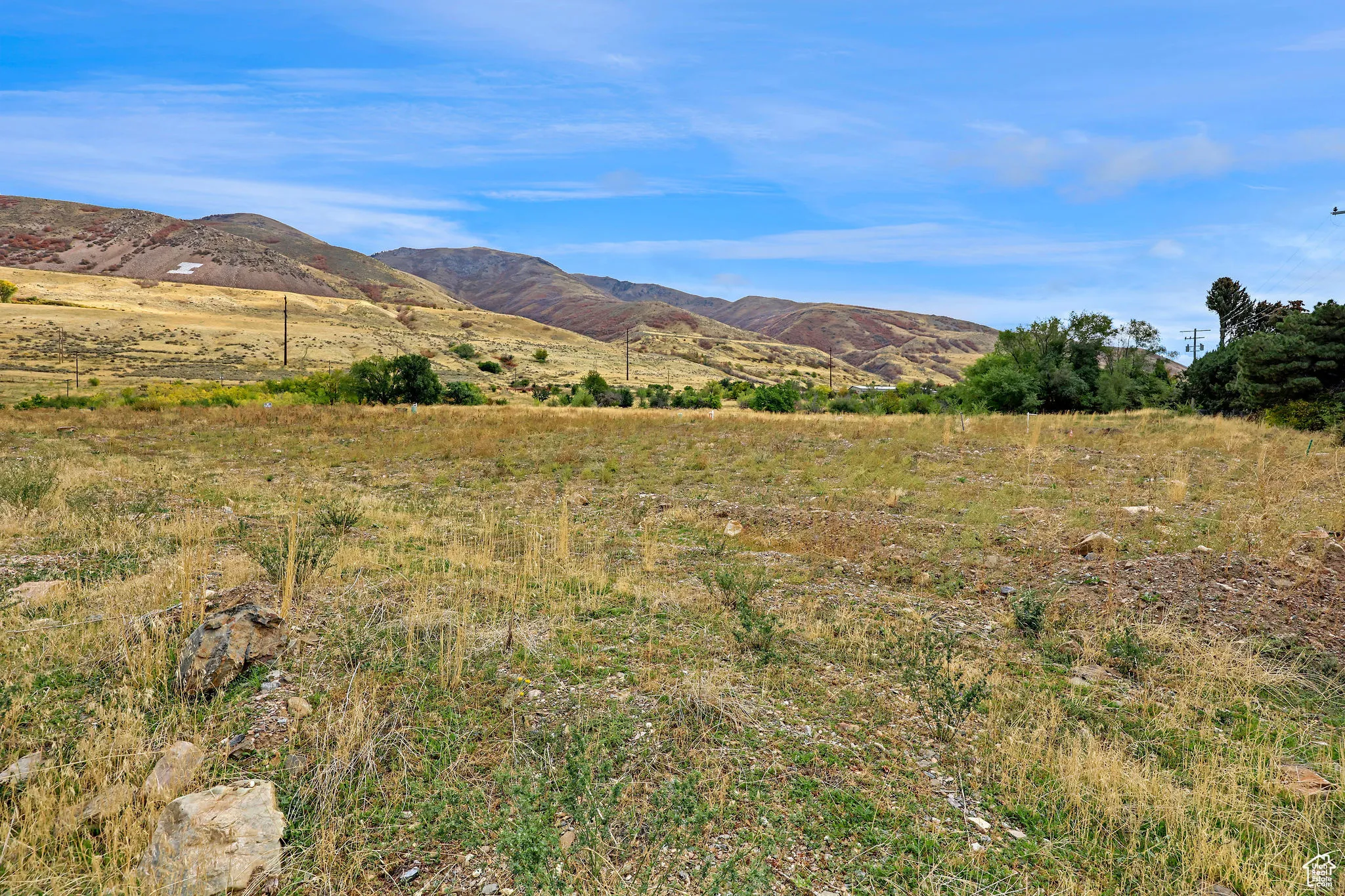 View of mountain backdrop featuring rural landscape