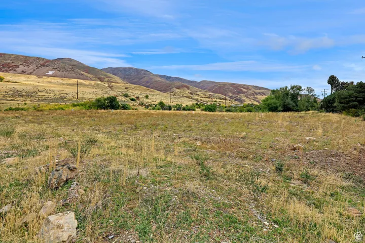 View of mountain backdrop featuring rural landscape