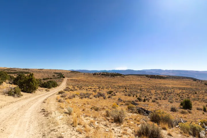 On the way to the property. View of mountain backdrop featuring a desert landscape and rural landscape