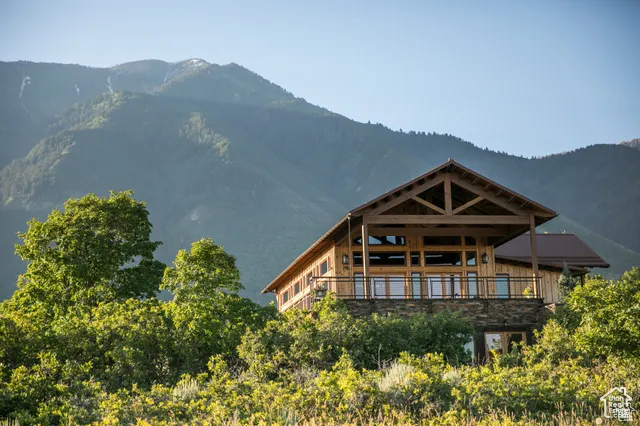 Back of property with a mountain view