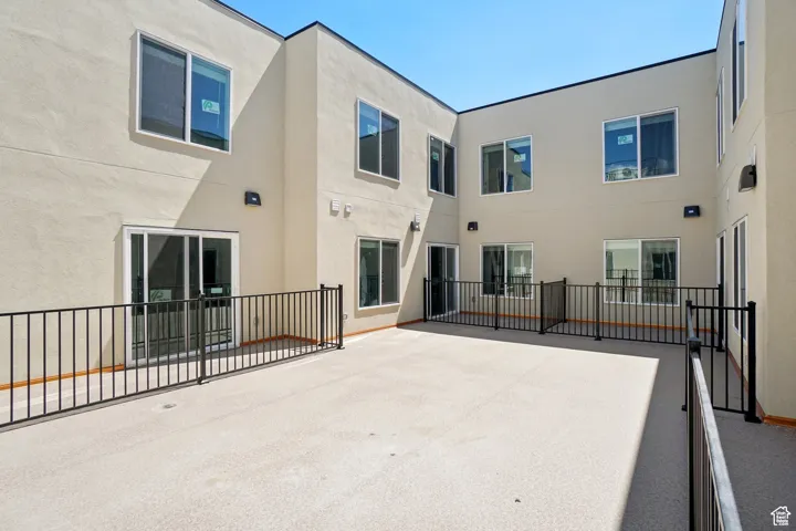 Rear view of property with a patio area and stucco siding