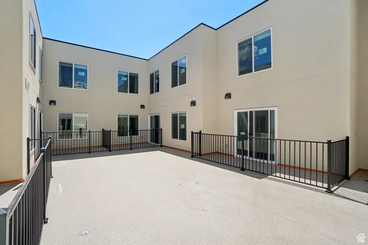 Rear view of house with a patio and stucco siding