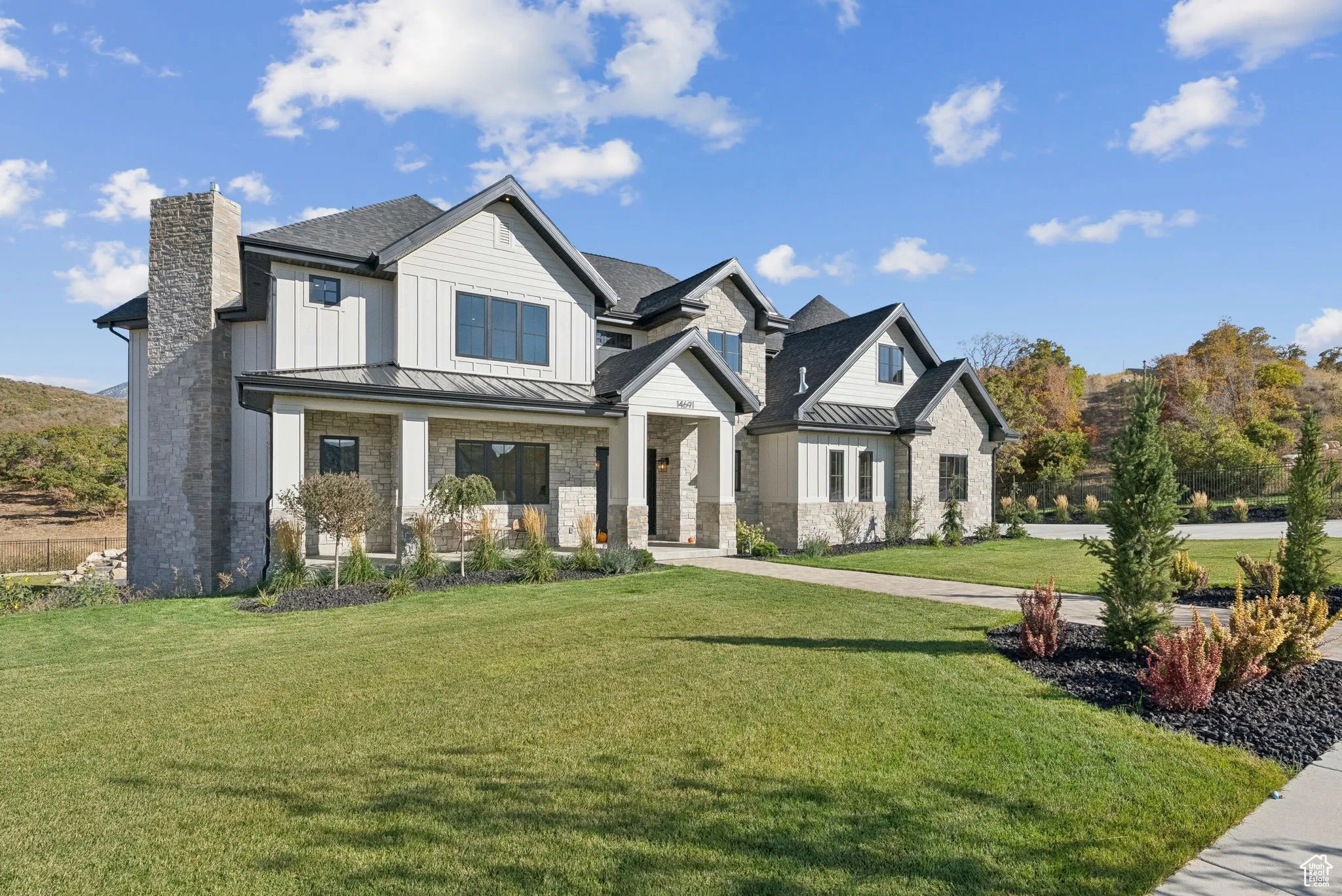 Modern inspired farmhouse featuring a standing seam roof, a metal roof, and a front yard