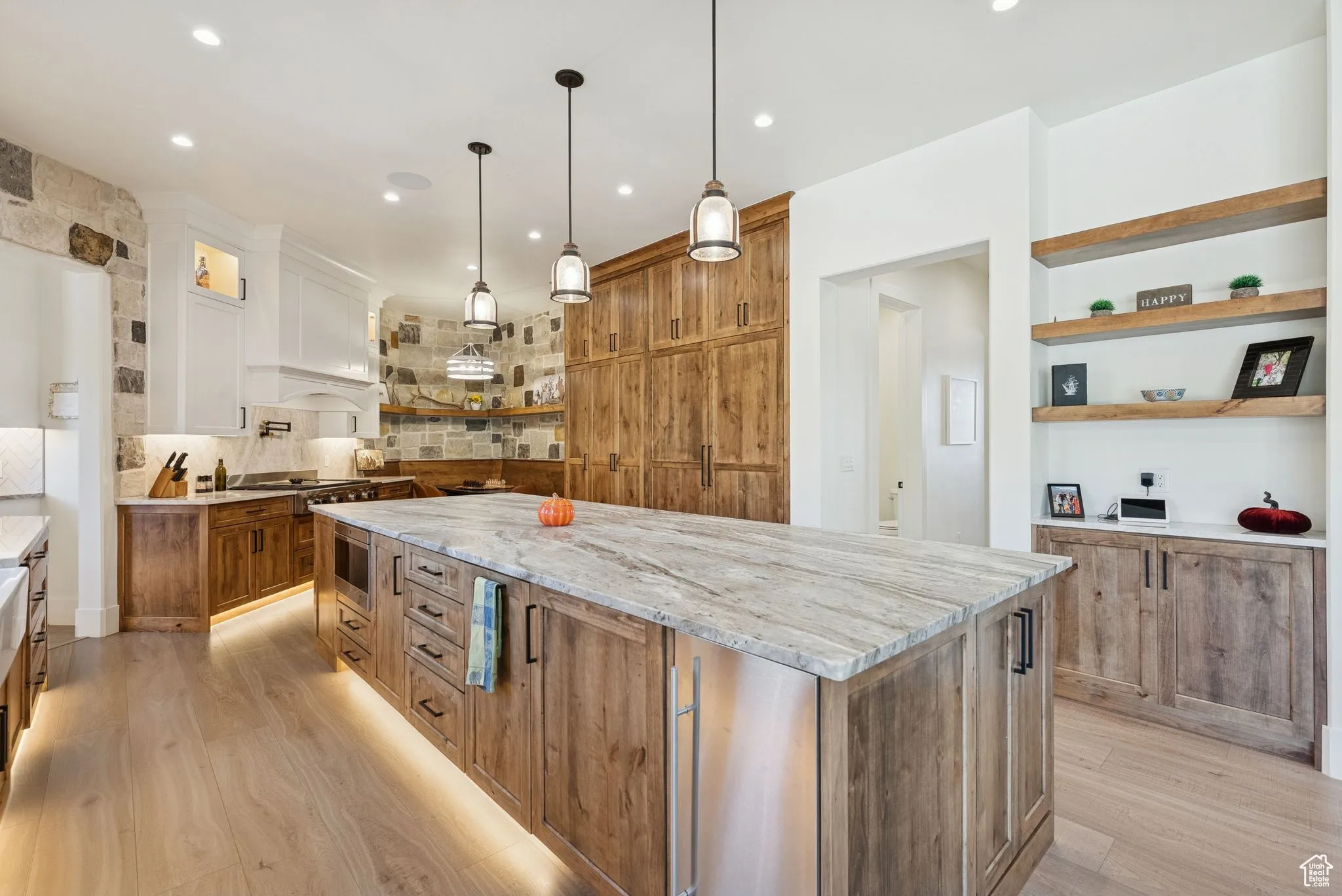 Kitchen with open shelves, brown cabinetry, light stone countertops, light wood-style floors, and recessed lighting