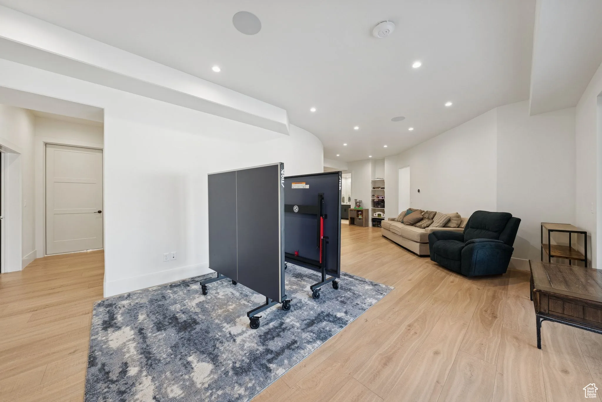 Living area with recessed lighting and light wood finished floors