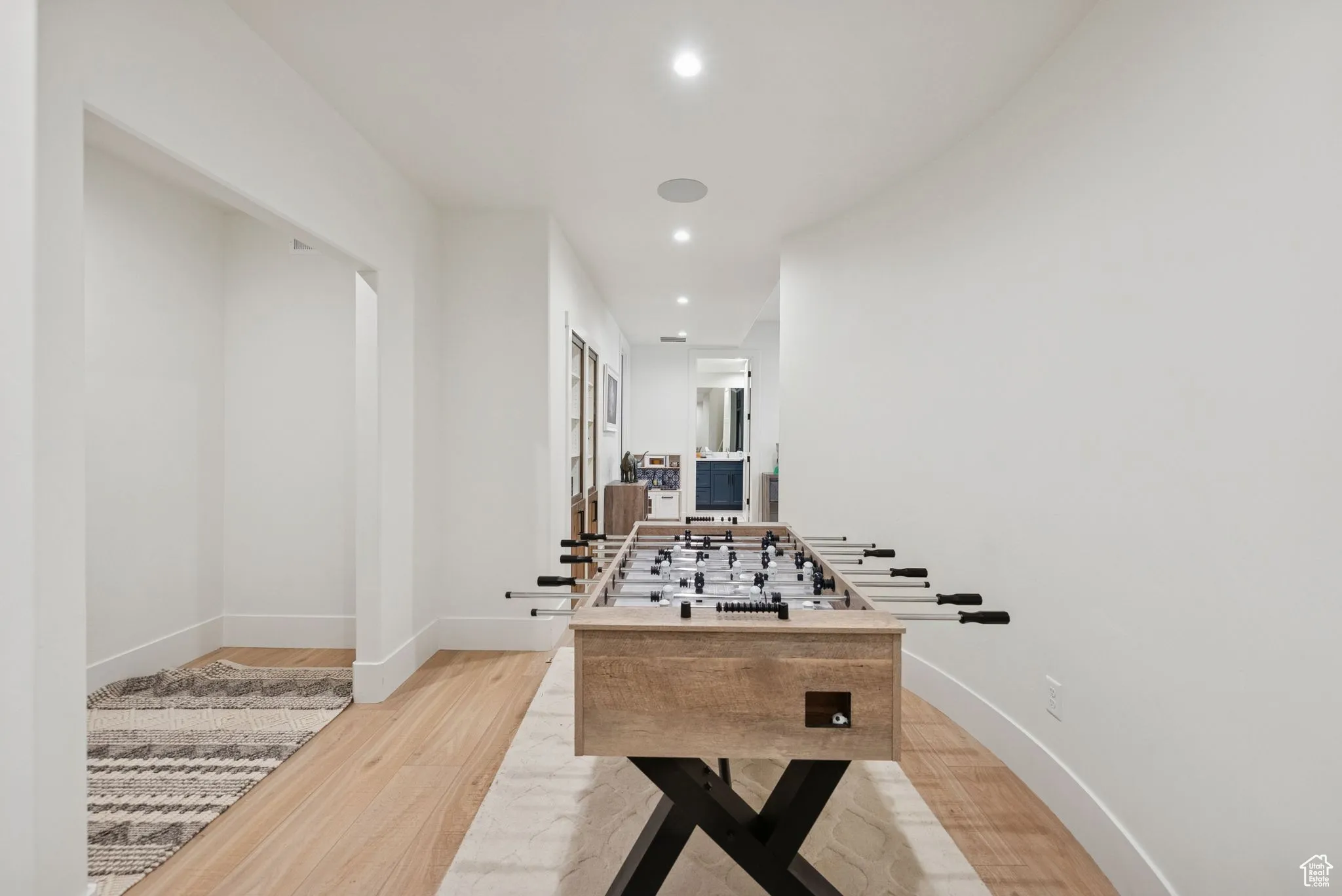 Recreation room featuring light wood-style flooring and recessed lighting