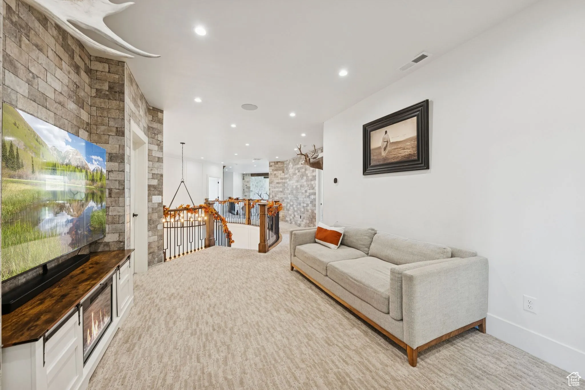 Sitting room featuring an upstairs landing, light carpet, and recessed lighting
