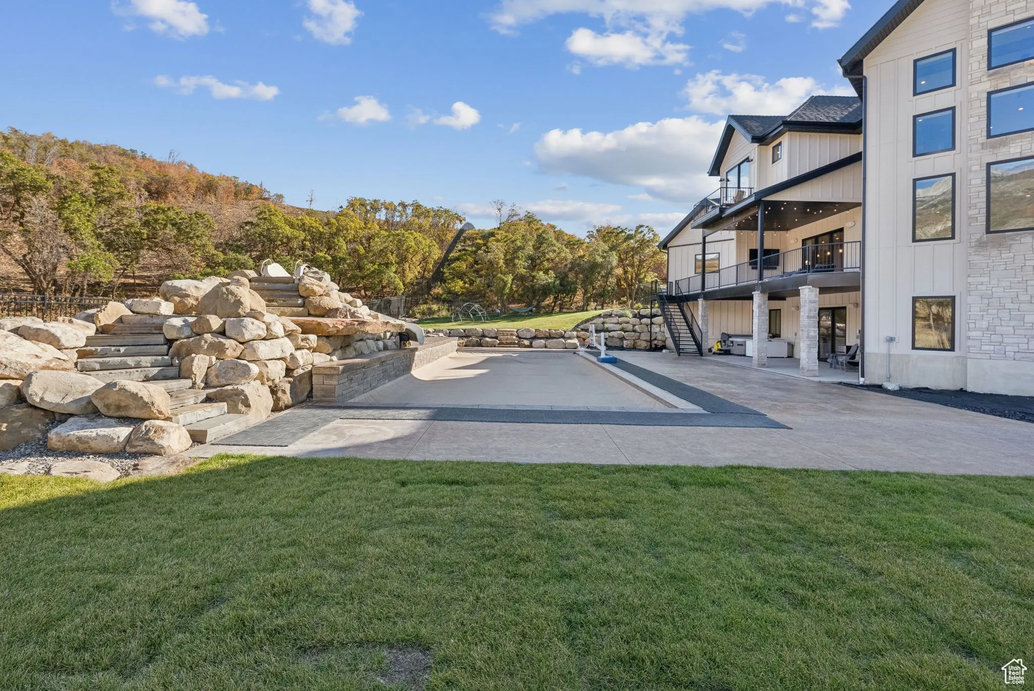 View of community with stairway, a patio, a balcony, and a lawn