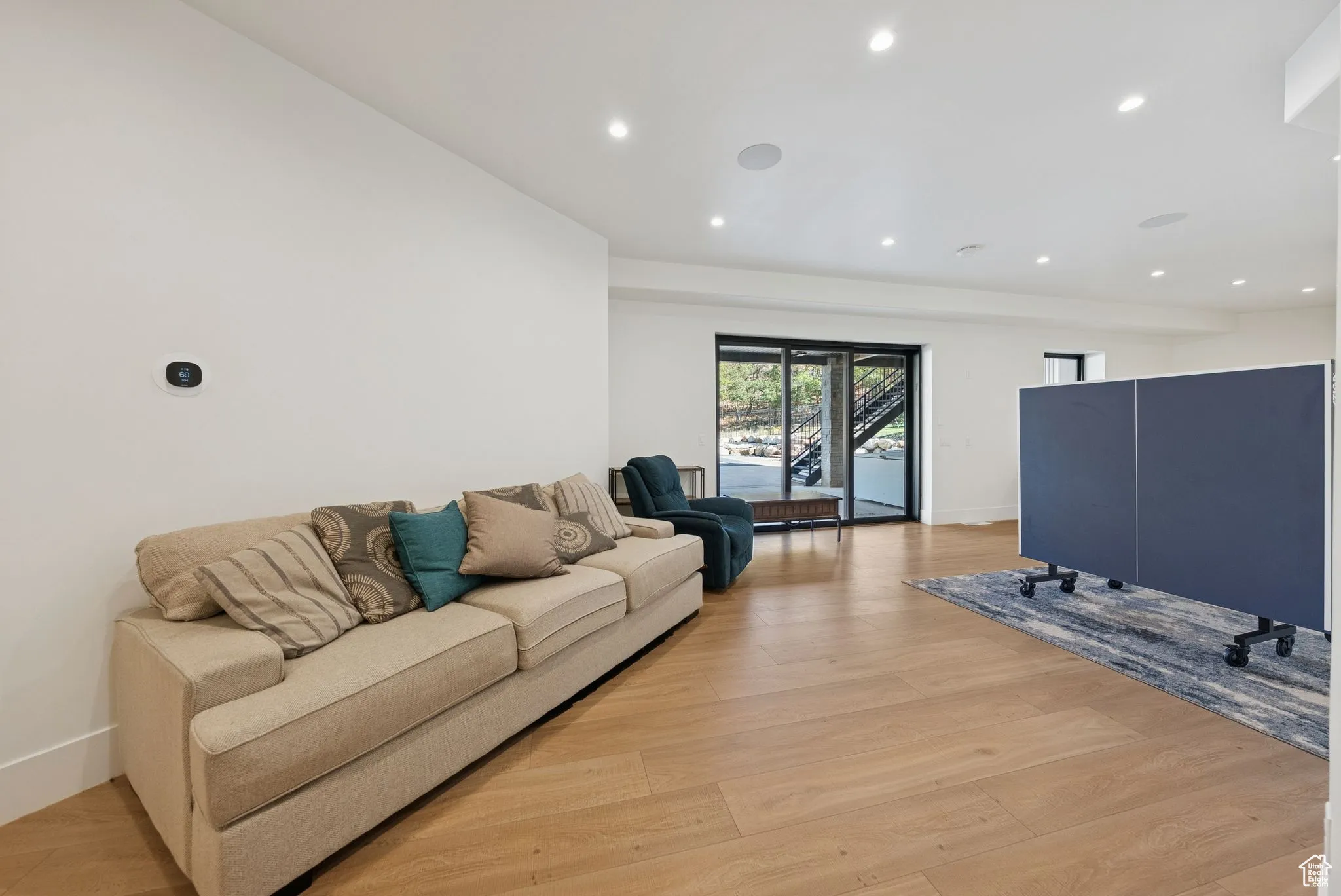 Living room featuring light wood-style flooring and recessed lighting