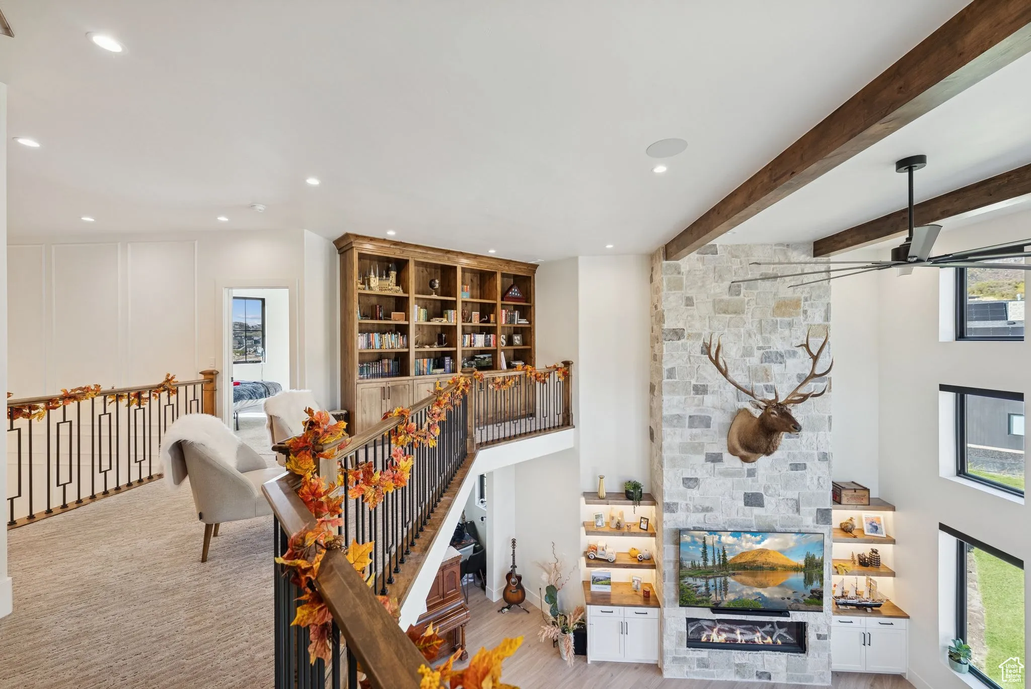 Bar with a stone fireplace, recessed lighting, wood finished floors, and beam ceiling