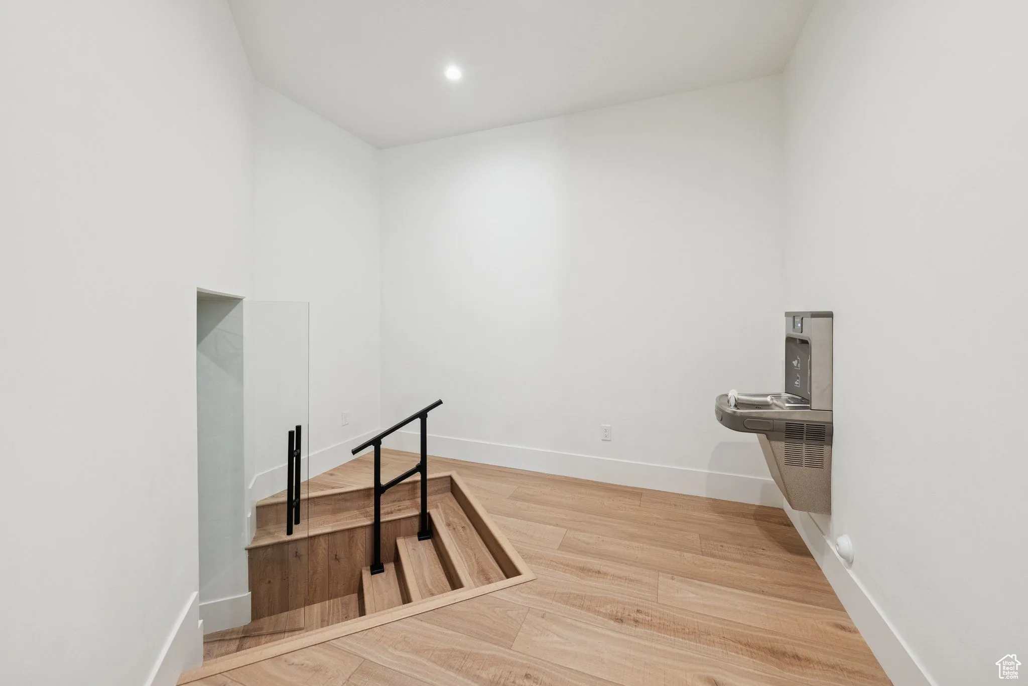Interior space with light wood finished floors and recessed lighting