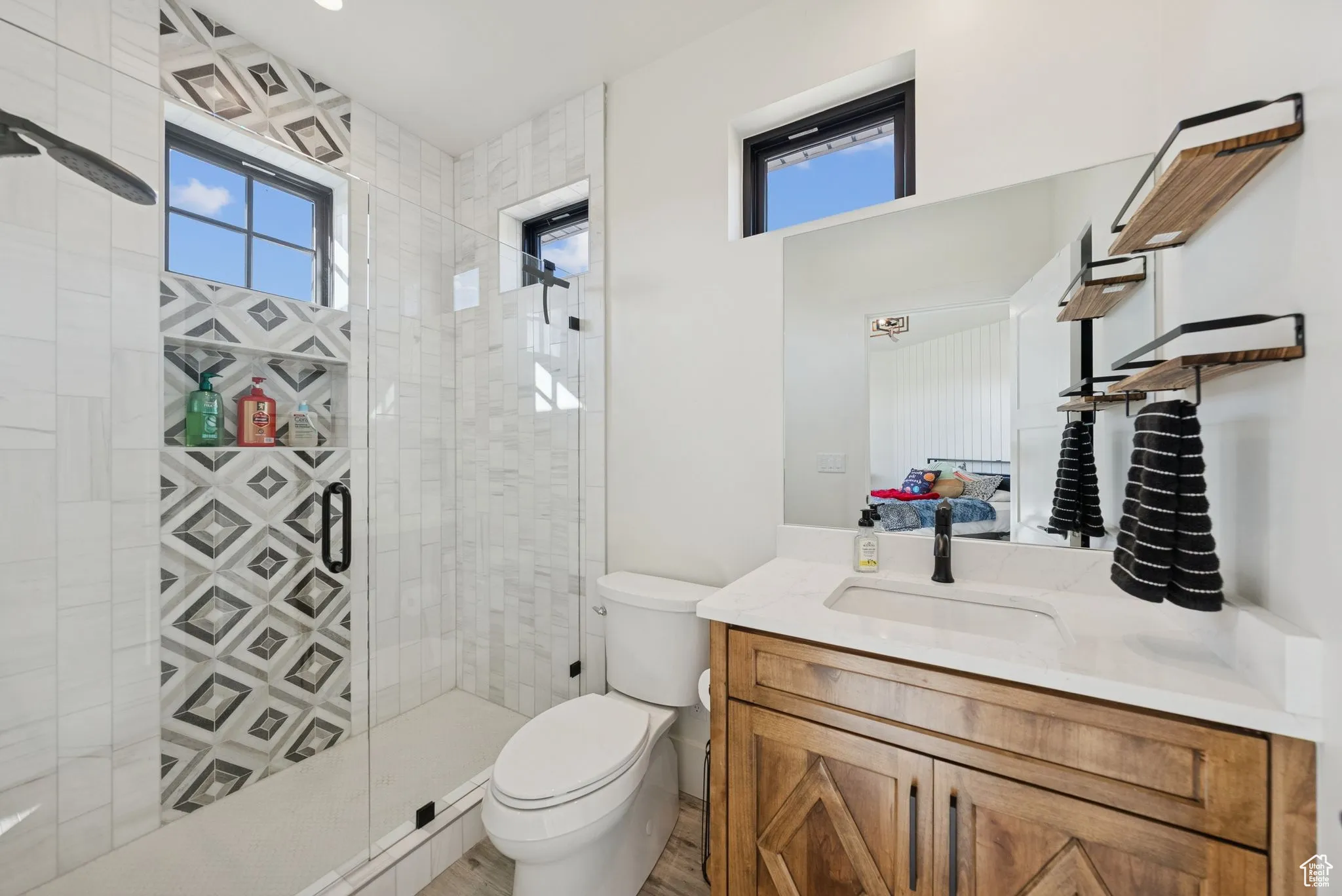 Bathroom featuring vanity and a stall shower
