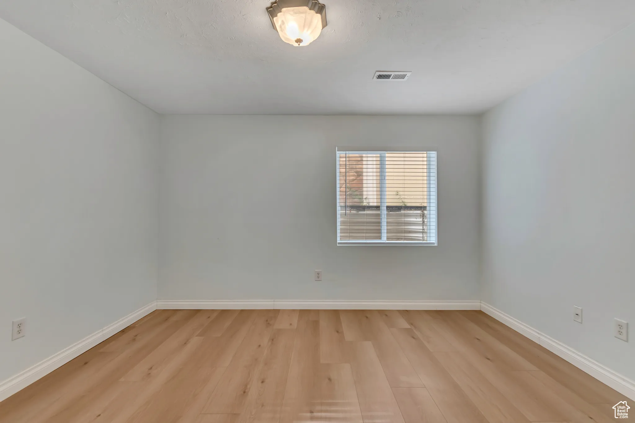 Basement bedroom with baseboards and light wood-type flooring
