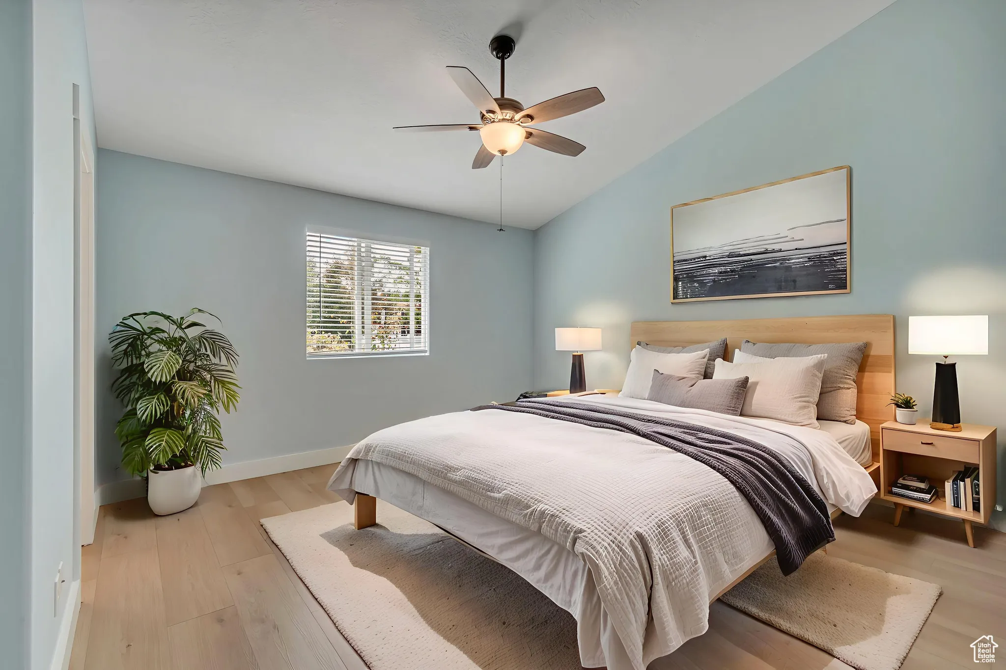VIRTUALLY STAGED -- Primary bedroom with light wood-style floors, a ceiling fan, and ensuite bath