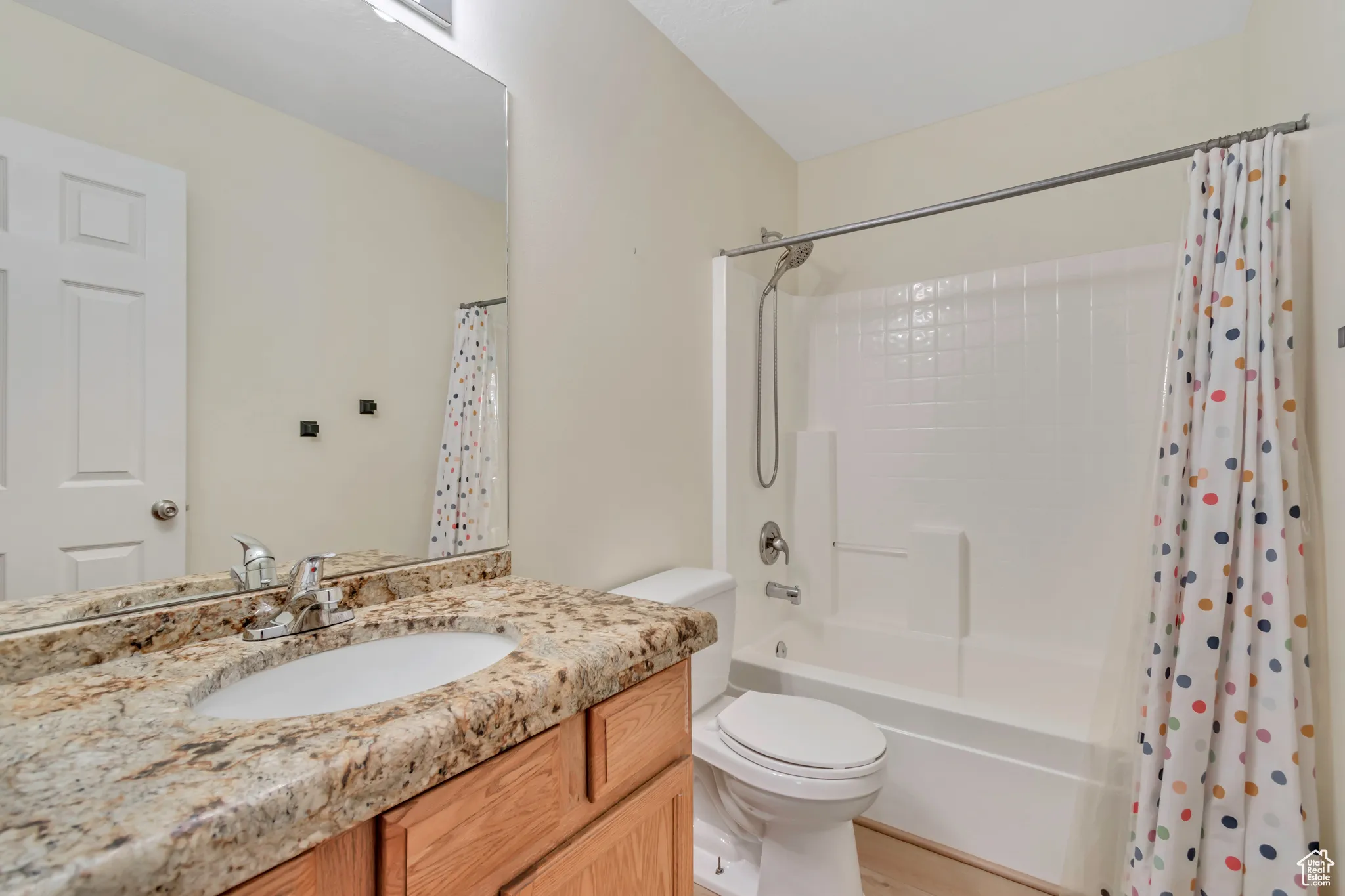 Full bath featuring shower / bath combo with shower curtain and vanity