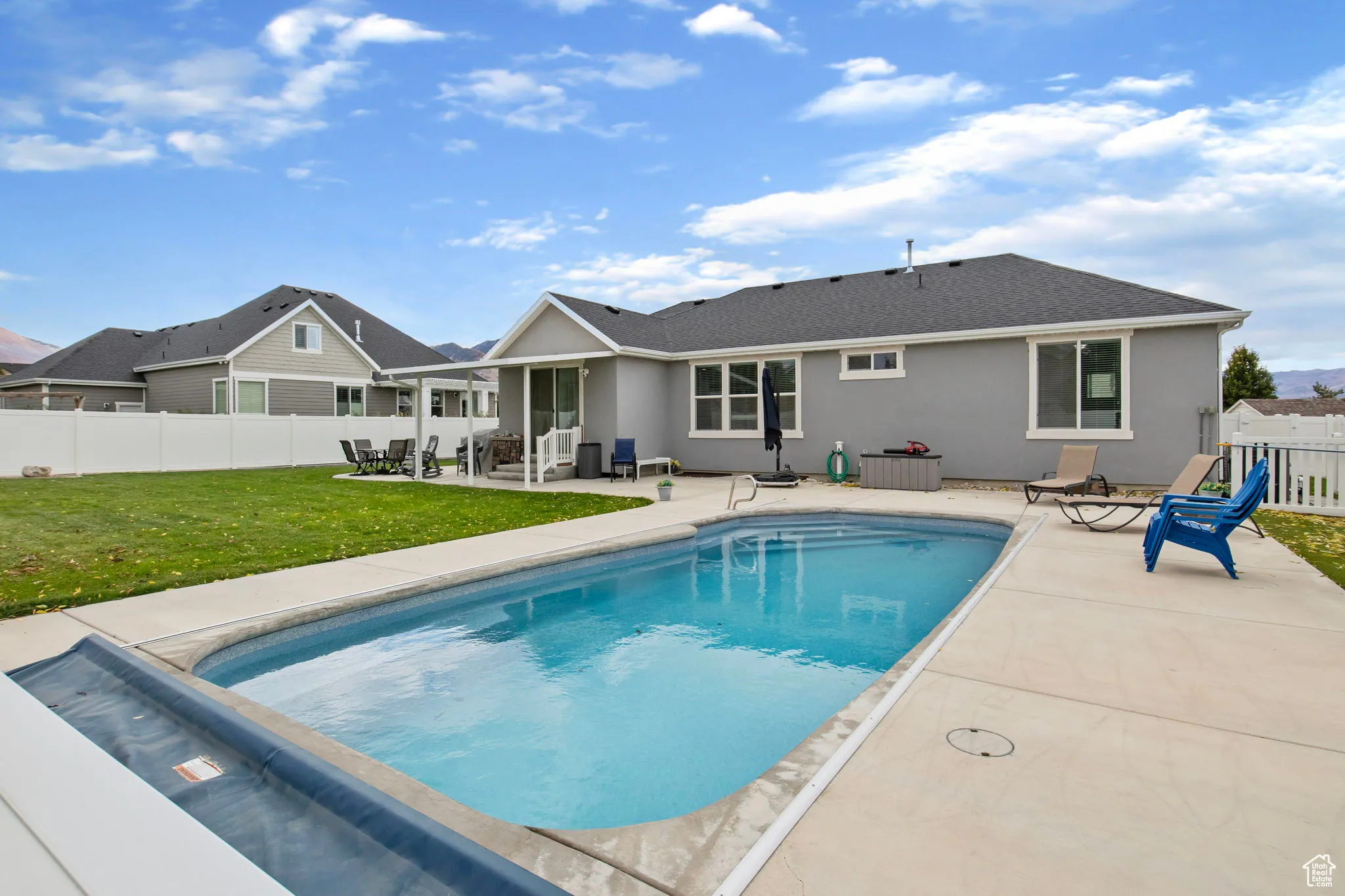 View of swimming pool with a patio and a fenced backyard