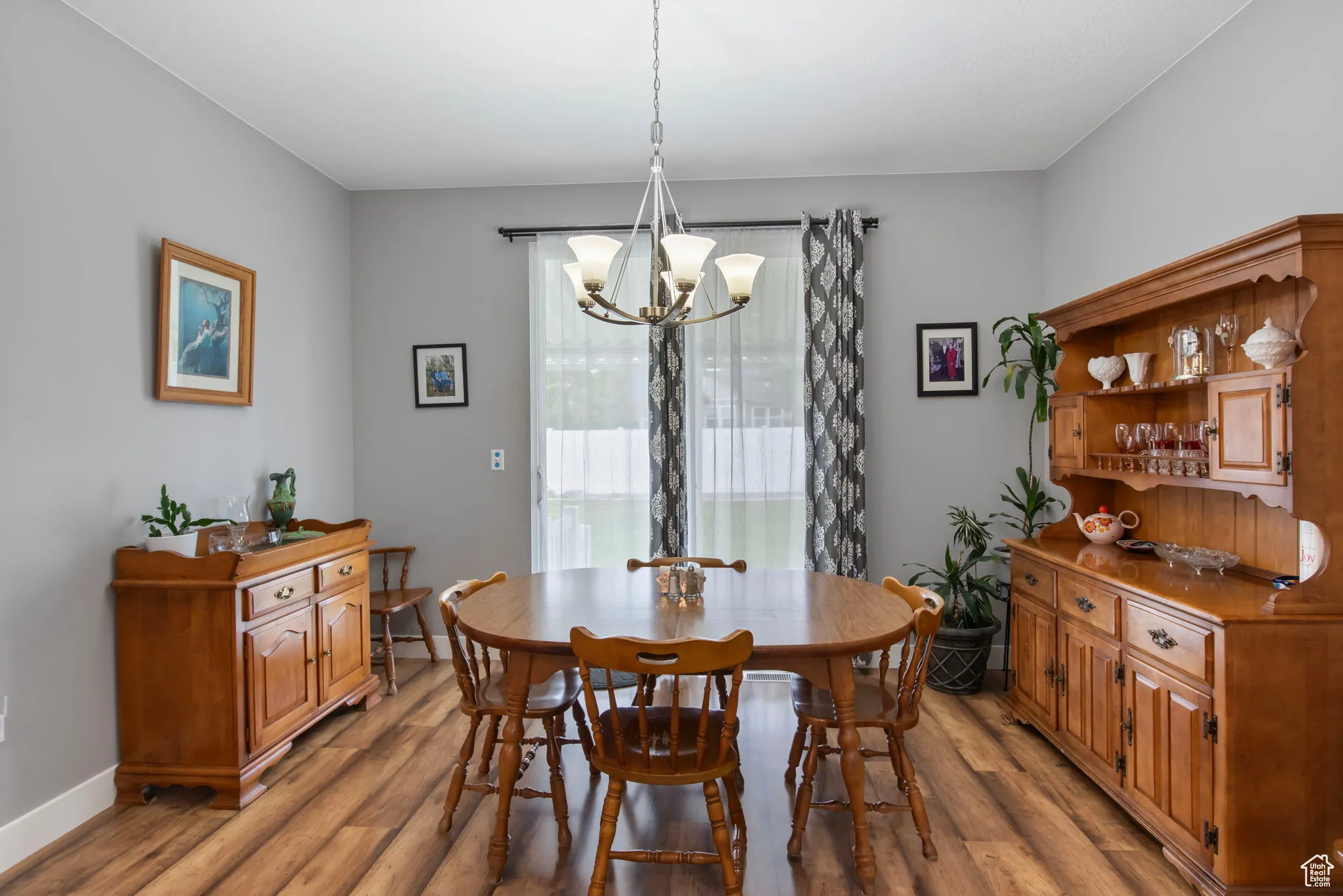 Dining area with wood finished floors and a chandelier